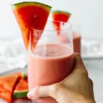 Smoothie rafraîchissant à la pastèque dans un verre avec des morceaux de fruit